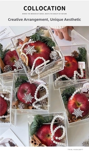 Detail view of acrylic Christmas gift box with pine cones and cinnamon sticks