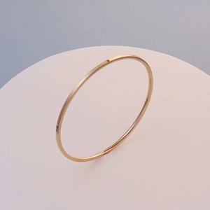 Polished 18K gold-plated minimalist stacking thin bangles in a stylish group display