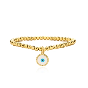 Macro view of gold-plated beaded bracelet featuring a detailed evil eye charm