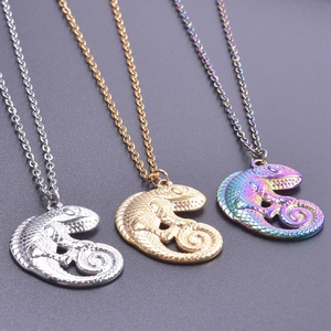 Detailed close-up of chameleon lizard pendants in silver, gold, and rainbow finish