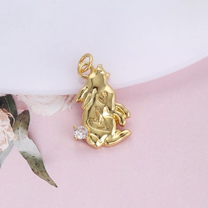 Close-up of golden bunny pendant with heart engraving and sparkling gemstone