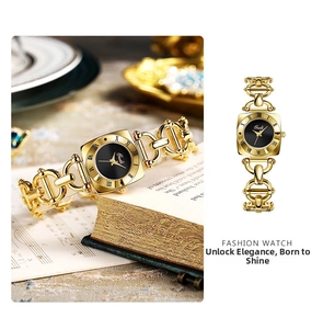 Detail of Gedi vintage gold watch with black dial and unique link bracelet on book background