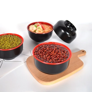 Traditional Japanese style red and black melamine soup bowl with lid on wooden tray