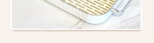 Detail of a white rectangular drainage tray with silver metal handles and beige grid