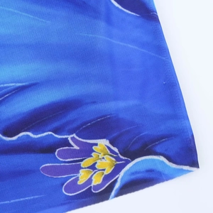 Close-up of blue floral print fabric with purple and yellow flower texture