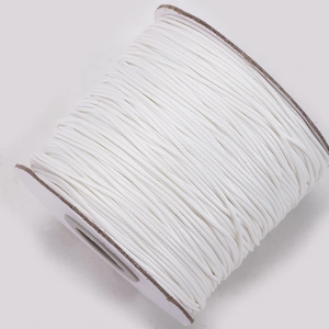 Macro detail of high-quality white waxed polyester cord spool for DIY jewelry making