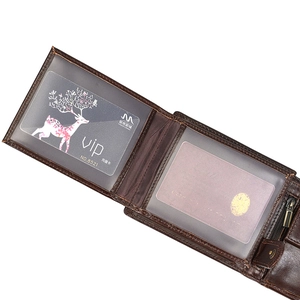 Close-up of genuine brown leather wallet showing multiple card slots and zipper pocket