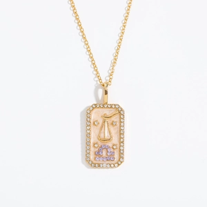 Macro detail of Libra zodiac pendant with purple crystals and white zircon square frame