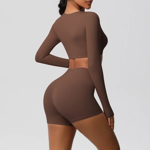 Back view of brown long sleeve crop top and high waist sports shorts on a fitness model