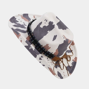 Top view of white cow print cowboy hat with colorful ethnic embroidery and leather bow
