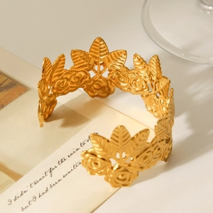 Detail of 18K gold floral leaf cuff bangle with intricate matte textured petals