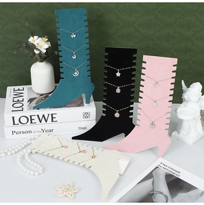 Detail view of suede boot-shaped necklace display boards in four elegant colors