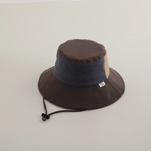 Detail of color-block kids bucket hat with reinforced stitching and adjustable chin cord