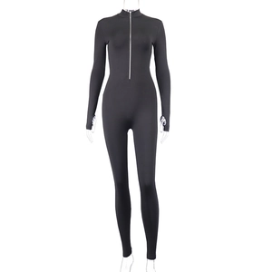 Front detail of black slim fit jumpsuit with stand collar and silver metal zipper
