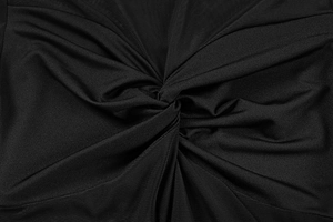 Close-up of the elegant twist knot design on the front of a black mesh v-neck dress