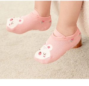 Close-up of pink cotton baby socks with cartoon rabbit pattern and strawberry detail