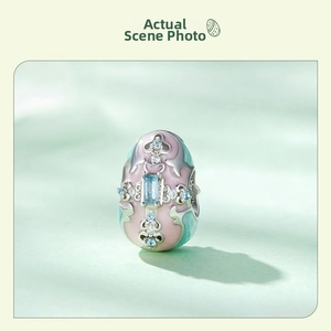 Detailed close-up of a vintage s925 silver Easter egg charm with enamel and blue gemstones