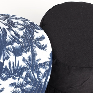 Detailed close-up of double-sided cotton bucket hat featuring palm tree print and fine stitching
