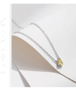 Detail of S925 sterling silver necklace with a yellow pear-cut teardrop gemstone