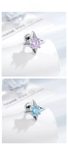 Detail of four-pointed star stud earrings with pink and blue gemstones and screw backs