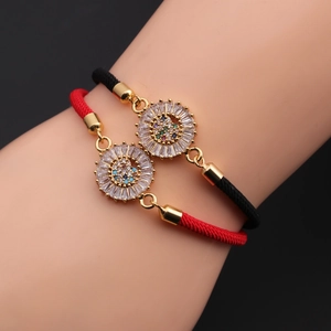 Detailed view of adjustable woven bracelets with gold sunflower beads and colorful zircon