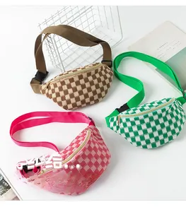 Macro view of checkered fanny packs in brown, green, and pink with adjustable straps