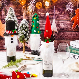 Gnome wine bottle covers with reindeer and snowman hats for Christmas party table decor