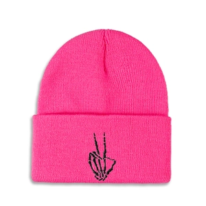 Detail of hot pink ribbed knit beanie featuring black skeleton hand peace sign embroidery