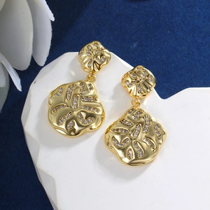 Macro detail of geometric heart star earrings with 14K gold plating and zircons