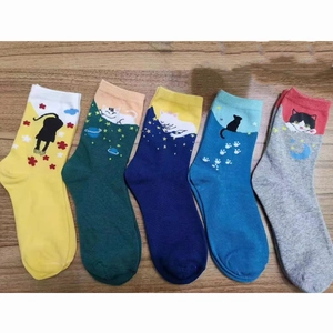 Row of five colorful cotton blend socks featuring various cartoon cat faces and ears