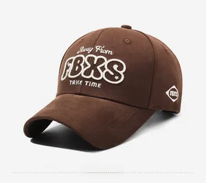 Detailed embroidery on dark brown cotton baseball cap showing fine stitching and texture