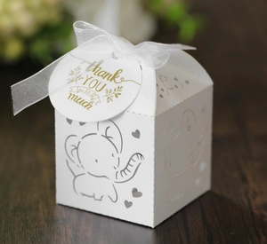 Detailed laser-cut white elephant gift box with organza ribbon and thank you tag