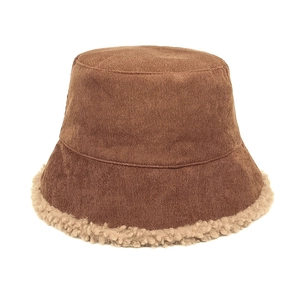 Detail of dark brown corduroy fisherman hat with soft beige lamb wool trim for winter