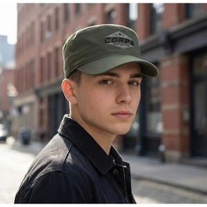 Detail of army green cadet cap with embroidered corps expedition patch and cotton texture
