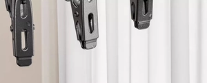 Detail of durable black metal laundry clip with spring structure for sock drying rack