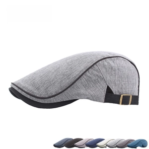 Detail of vintage plaid newsboy cap showing grey woven texture and bronze metal buckle