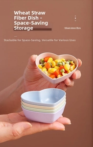 Detail of eco-friendly wheat straw heart-shaped seasoning dishes in pastel colors