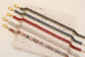 Macro view of five 18K gold plated bracelets set with colorful rectangular zircons