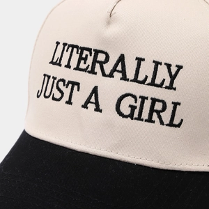 Detailed view of Literally Just A Girl embroidery on a contrast color cotton baseball cap
