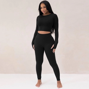 Women's black long sleeve crop top and high waist yoga leggings set for fitness