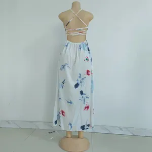 Detail of backless floral maxi dress featuring crisscross lace-up straps and split hem