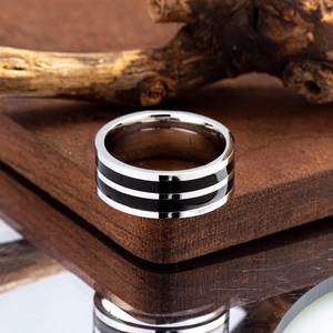 Macro shot of silver titanium steel ring featuring parallel black enamel inlay stripes