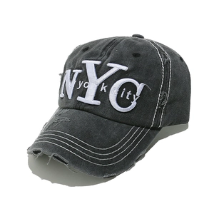 Close-up of NYC 3D embroidery on vintage washed black distressed baseball cap