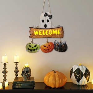 Detail of Halloween welcome sign featuring ghost and pumpkins on a rustic wall display