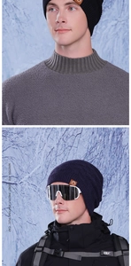 Detail of dark blue knit beanie featuring thick diamond pattern and brown leather patch