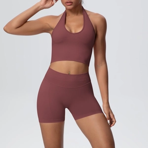 Detail of seamless ribbed halter yoga bra and high waist shorts in dark reddish brown