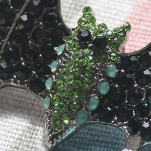 Exaggerated silver bat brooch with sparkling black and green rhinestones for suits