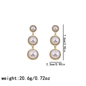 Three-tier golden circular drop earrings with faux pearls and rhinestones size detail