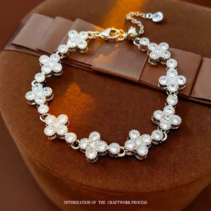 Sparkling zircon clover bracelet in silver finish displayed on a luxury velvet jewelry box