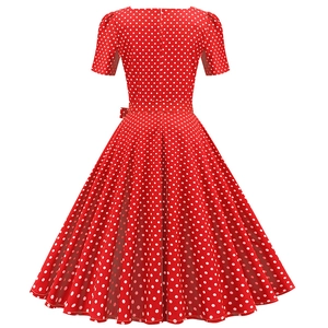 Back view of a red short-sleeve dress with white polka dots and flared A-line hemline